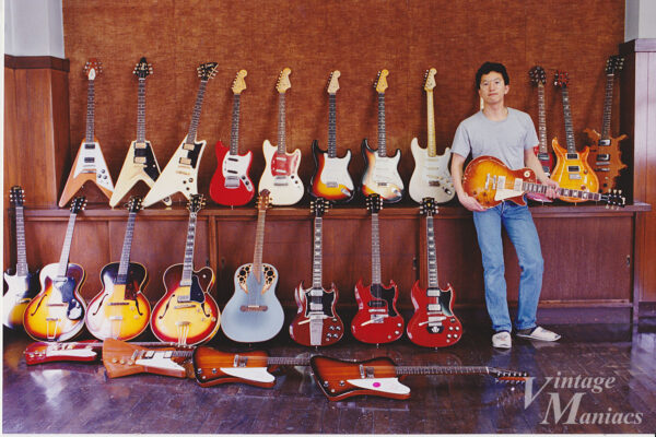 世田谷の独身寮でギターを持つ著者
